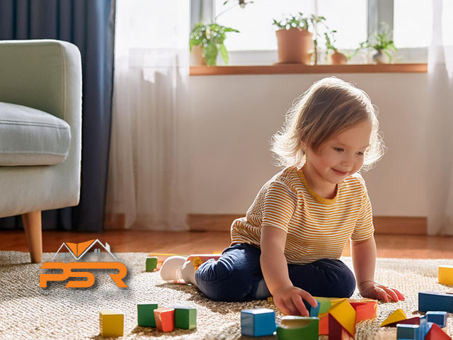 young child playing in living room on carpet